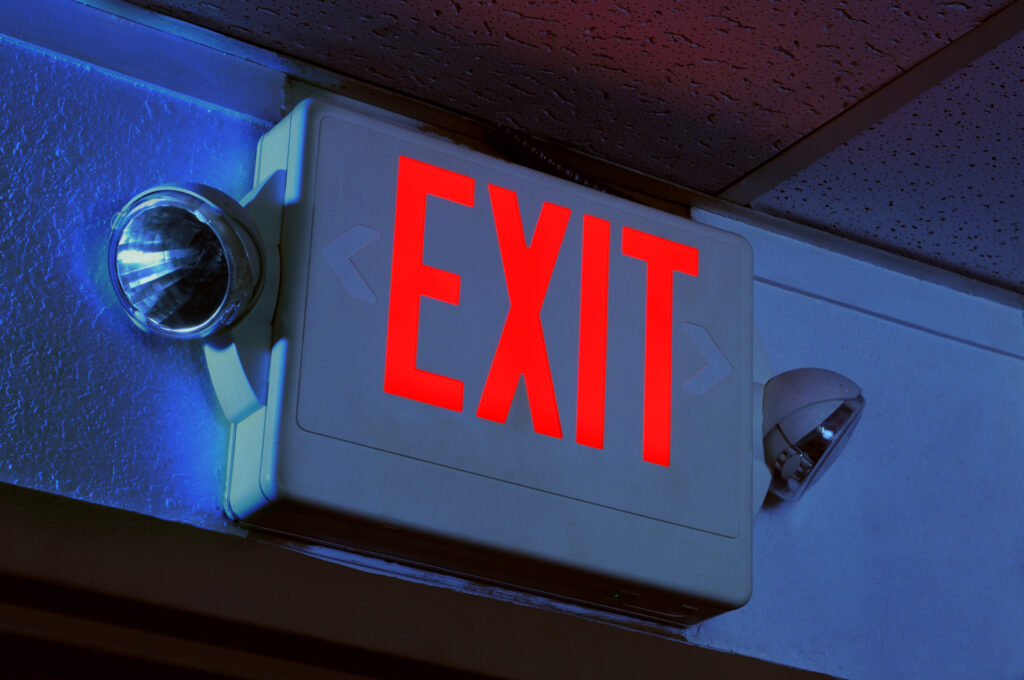 Exit sign illuminated in the dark
